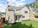 Rear view of house highlighting the beige siding, covered patio, and landscaping at 216 Wakehurst Way, Marietta, GA 30064