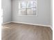 Bright bedroom with neutral walls and wood-look flooring at 6180 Chastain Way, Fairburn, GA 30213