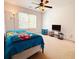 Bedroom with neutral carpet, ceiling fan, and large window to allow natural light at 1328 Stone Bay Sw Dr, South Fulton, GA 30331