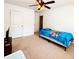 Bedroom with neutral carpet, ceiling fan and two doors to access closets or bathrooms at 1328 Stone Bay Sw Dr, South Fulton, GA 30331