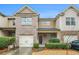 Charming townhome with brick and siding exterior, attached garage, and well-maintained landscaping at 1328 Stone Bay Sw Dr, South Fulton, GA 30331
