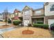 Charming townhome with brick and siding exterior, attached garage, and well-maintained landscaping at 1328 Stone Bay Sw Dr, South Fulton, GA 30331