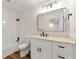 Bathroom with white vanity, large mirror, and modern fixtures at 2473 Baker Rd, Atlanta, GA 30318