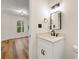 Small bathroom with white vanity, quartz countertop, and black matte fixtures at 2473 Baker Rd, Atlanta, GA 30318