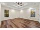 Spacious bedroom with ceiling fan, large windows, and hardwood floors at 2473 Baker Rd, Atlanta, GA 30318