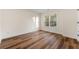 Bright bedroom with hardwood floors and a large window at 2473 Baker Rd, Atlanta, GA 30318