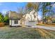 Two-story house with white siding, new garage door, and stone accents at 2473 Baker Rd, Atlanta, GA 30318
