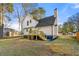 White two-story house with a deck and landscaped yard at 2473 Baker Rd, Atlanta, GA 30318