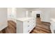 White kitchen island with drawers and quartz countertop, open to living area at 2473 Baker Rd, Atlanta, GA 30318