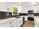 Modern kitchen with white cabinets, black tile backsplash, and stainless steel appliances at 2473 Baker Rd, Atlanta, GA 30318