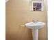 Small bathroom with pedestal sink and beige walls at 348 Red Oak Run, Marietta, GA 30008