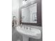 Powder room with pedestal sink and decorative mirror at 6412 Wedgeview Dr, Tucker, GA 30084