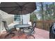 Deck with table, chairs, umbrella, and grill; overlooks wooded area at 6412 Wedgeview Dr, Tucker, GA 30084