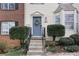 Inviting front entrance with a blue door and lush green shrubs on either side at 6412 Wedgeview Dr, Tucker, GA 30084