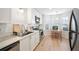 Updated kitchen with white cabinets, stainless steel appliances, and breakfast area at 6412 Wedgeview Dr, Tucker, GA 30084
