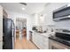 Modern kitchen with white cabinets, stainless steel appliances, and breakfast nook at 6412 Wedgeview Dr, Tucker, GA 30084