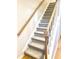 Carpeted staircase with wooden railings and neutral tones at 6412 Wedgeview Dr, Tucker, GA 30084