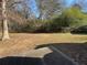 Simple backyard with a patio and mature trees at 1402 Chelsea Downs Ne Ln, Conyers, GA 30013