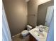 Clean bathroom with single sink vanity, toilet, and mirror at 1402 Chelsea Downs Ne Ln, Conyers, GA 30013