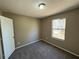 Simple bedroom with carpet flooring and a window at 1402 Chelsea Downs Ne Ln, Conyers, GA 30013