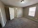Well-lit bedroom with access to another room and carpet at 1402 Chelsea Downs Ne Ln, Conyers, GA 30013