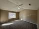 Large bedroom with vaulted ceiling, carpet flooring, and ample natural light at 1402 Chelsea Downs Ne Ln, Conyers, GA 30013