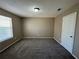 Bright bedroom featuring a large window and carpet flooring at 1402 Chelsea Downs Ne Ln, Conyers, GA 30013