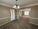 Dining room with chandelier, adjacent to living room and kitchen at 1402 Chelsea Downs Ne Ln, Conyers, GA 30013
