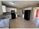 Bright kitchen featuring white cabinets, black appliances, and speckled countertops at 1402 Chelsea Downs Ne Ln, Conyers, GA 30013