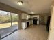 Kitchen with white cabinets, tile floor, and sliding glass door to backyard at 1402 Chelsea Downs Ne Ln, Conyers, GA 30013