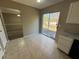 Kitchen with white cabinets, tile floor, and access to backyard and dining area at 1402 Chelsea Downs Ne Ln, Conyers, GA 30013