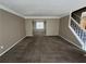 Bright living room with carpeting, neutral walls, and view into dining area at 1402 Chelsea Downs Ne Ln, Conyers, GA 30013