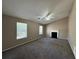 Spacious living room with vaulted ceiling, fireplace, and carpet flooring at 1402 Chelsea Downs Ne Ln, Conyers, GA 30013