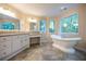 Bathroom with soaking tub, double vanity, and tile floors at 5490 Powers Overlook Ct, Atlanta, GA 30327