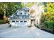 Two-story house with a white garage door and landscaped yard at 5490 Powers Overlook Ct, Atlanta, GA 30327