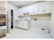 Bright laundry room with built-in cabinets and storage at 5490 Powers Overlook Ct, Atlanta, GA 30327
