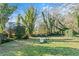 Large backyard with mature trees and open space at 3935 Loganville Hwy, Loganville, GA 30052