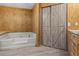 Bathroom with corner tub and barn door at 3935 Loganville Hwy, Loganville, GA 30052