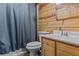 Clean bathroom with wood-paneled walls and a shower/tub combo at 3935 Loganville Hwy, Loganville, GA 30052