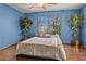 Blue bedroom with wood floors and large windows at 3935 Loganville Hwy, Loganville, GA 30052