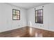 Bright bedroom with hardwood floors and two windows at 3935 Loganville Hwy, Loganville, GA 30052