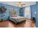 Blue bedroom with wood floors and large windows at 3935 Loganville Hwy, Loganville, GA 30052