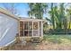Home exterior showcasing a screened porch and yard at 3935 Loganville Hwy, Loganville, GA 30052