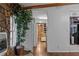 View of kitchen hallway with wood flooring and stone wall at 3935 Loganville Hwy, Loganville, GA 30052