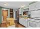 Galley kitchen with wood cabinets and modern appliances at 3935 Loganville Hwy, Loganville, GA 30052