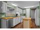 Kitchen with green walls, white cabinets, and wood countertops at 3935 Loganville Hwy, Loganville, GA 30052