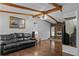 Spacious living room with leather couches and wood floors at 3935 Loganville Hwy, Loganville, GA 30052
