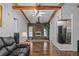 Living room features a stone fireplace and wood beams at 3935 Loganville Hwy, Loganville, GA 30052