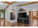 Living room with entertainment center and wood flooring at 3935 Loganville Hwy, Loganville, GA 30052