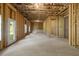 Unfinished basement featuring stud framing, concrete floor, a window and access door to the outside at 741 Cams Crk, Mcdonough, GA 30253